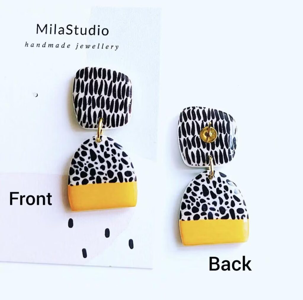 Earrings with a yellow stripe and black pattern on a white background.