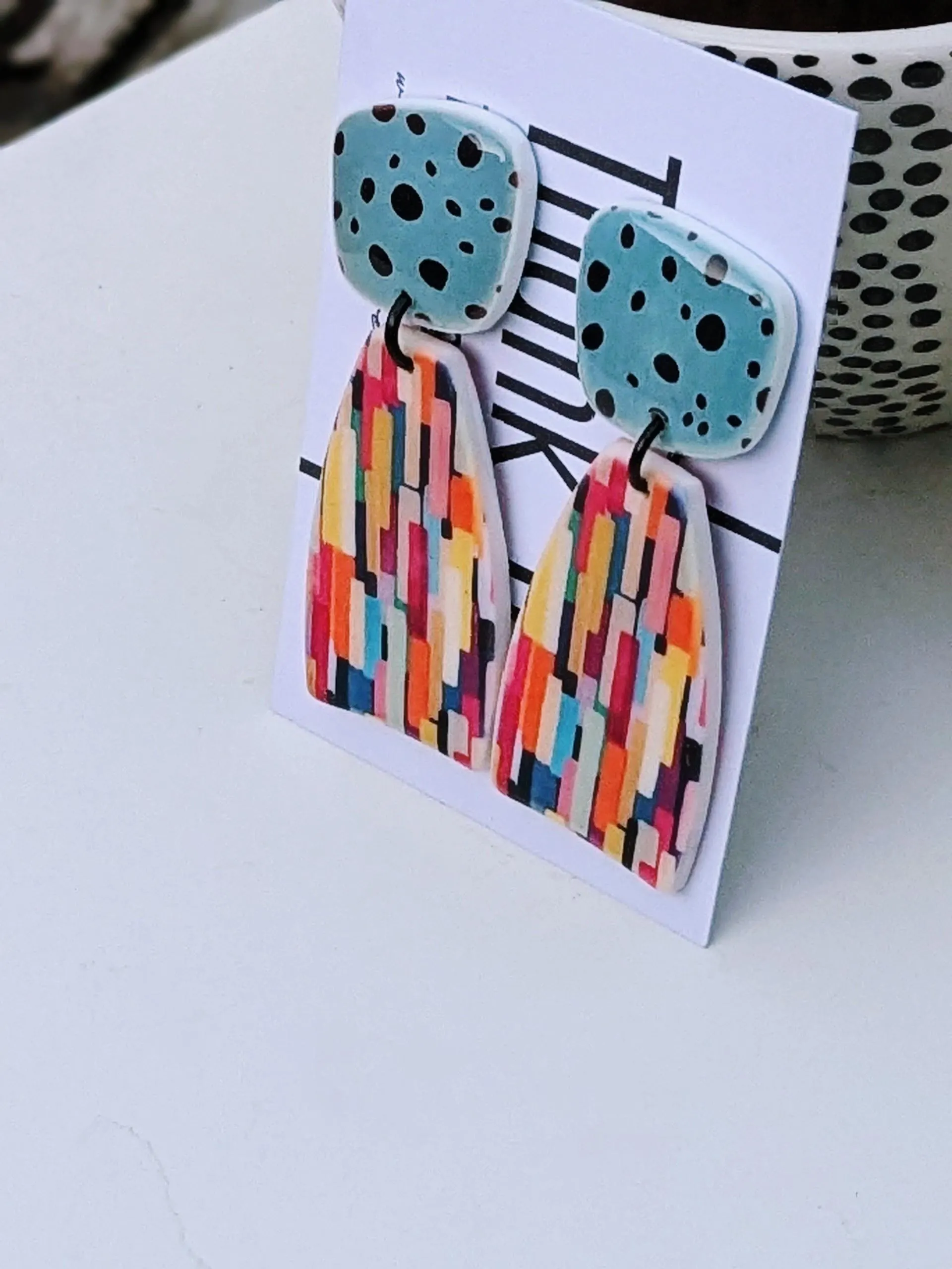 Multicolor earrings on an organic shape.