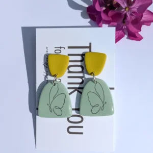 Green earrings with a butterfly design.