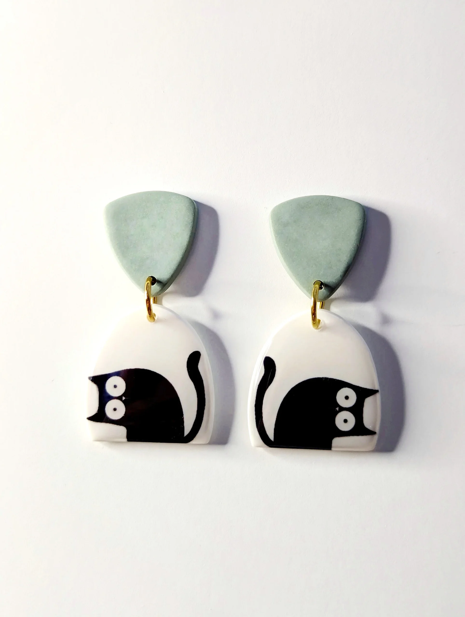 Polymer Clay black cat drop earrings with a green accent.
