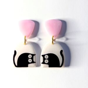 Black and white cat dangle earrings with a pink top.