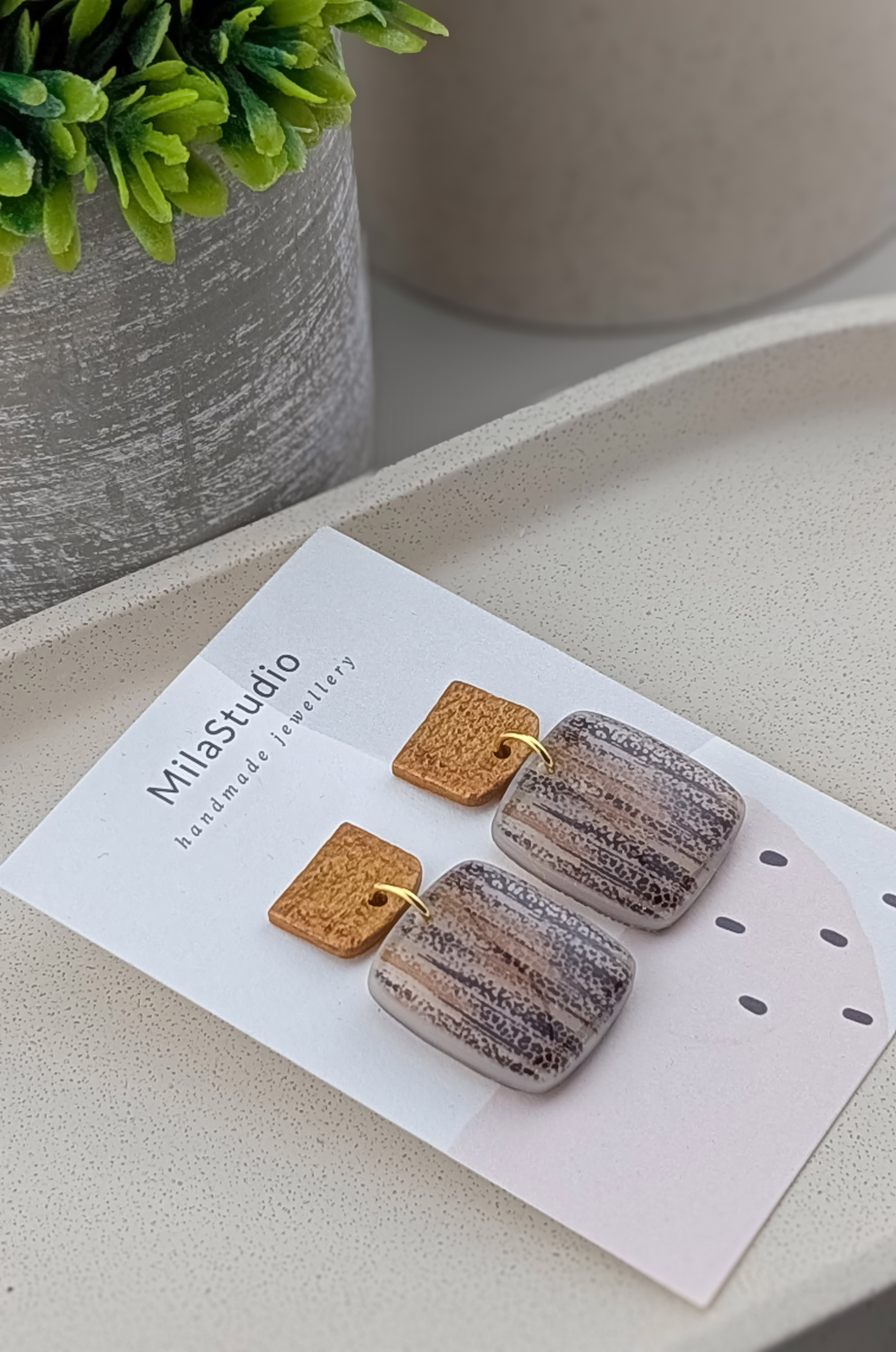 Detail of vertical "birch bark" texture on resin-coated jewellery.