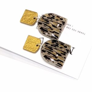 Pair of handmade Art Deco statement earrings with an abstract ochre and black patterned dangle and square gold-coloured hammered studs.